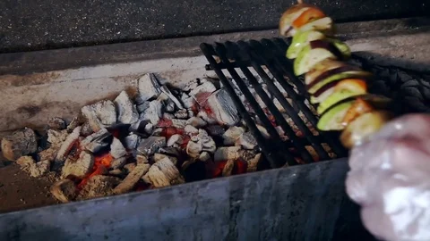 Man in gloves puts vegetable shish kebab on the grill Stock-Footage 80041490