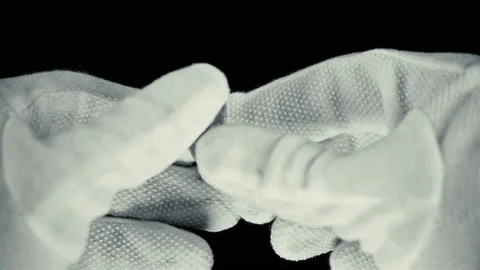 A man in gloves unfolds a note on a scrap of paper with the inscription: yes Stock Footage 91205556