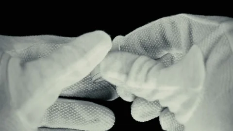 A man in gloves unfolds a note on a scrap of paper with the inscription: welcome Stock Footage 91211960