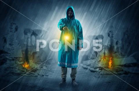 Man with a glowing lantern at a catastrophe scene Stock Photos