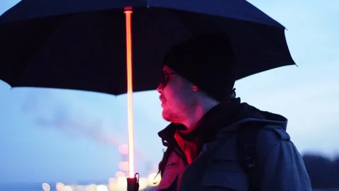 Man with glowing umbrella Stock Footage 230587949