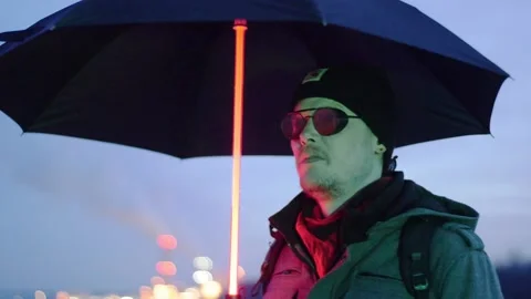Man with glowing umbrella Stock Footage 230588344