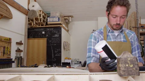 Man Glueing Custom Surfboard In Workshop Shot On RED Camera Stock Footage 64349155