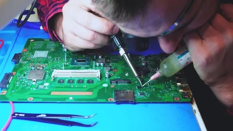 Man gluing a chip to a main board Stock Footage 104552576