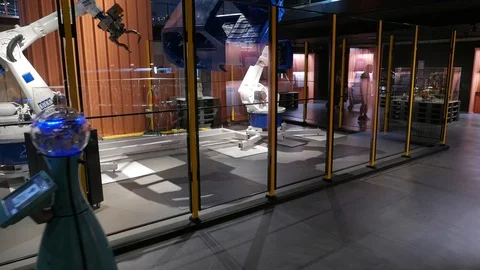 Man go after moving robot at science museum. Stock Footage 100315376