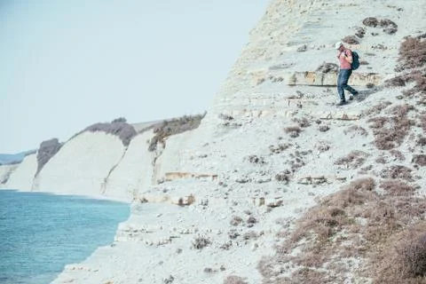 Man go down on steep coast Stock Photos