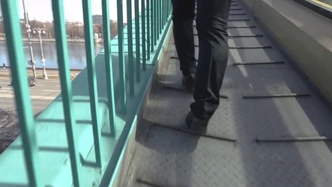 Man goes up to the bridge over the road. Stock Footage 80356059