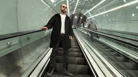 A man goes down on the escalator at the metro station Stock Footage 132020190