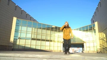 The man goes down the stairs talking on the phone Stock Footage 86048128