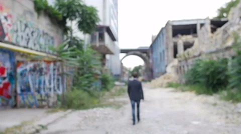 The man  goes down the street with the thrown buildings Stock Footage 57508031