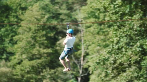 Man goes down the troll in the forest in a camp in nature1 Stock Footage 134488664