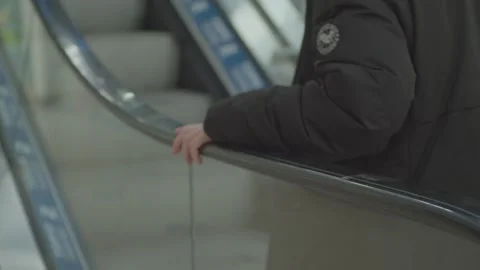 A man goes up an escalator in a store. Stock Footage 265573710
