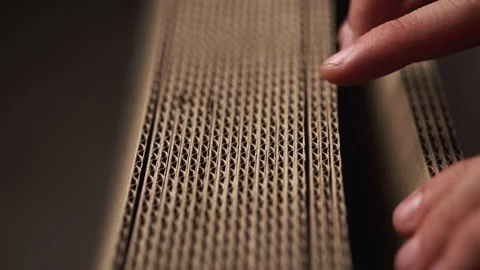 A man goes over a stack of cardboard with his hands. Stock Footage 142623592