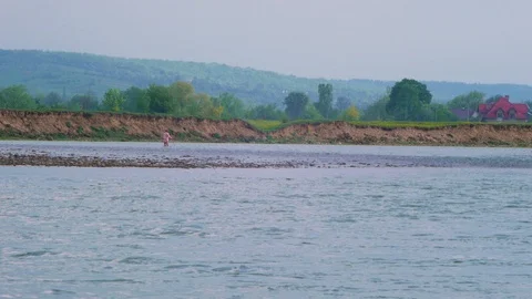 A man goes on the river against the stream Stock Footage 102562402