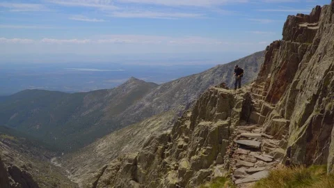 Man goes up the steep mountain Stock Footage 111267050