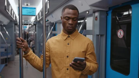 A man goes to the subway texting with colleagues in a smartphone Stock Footage 239322597