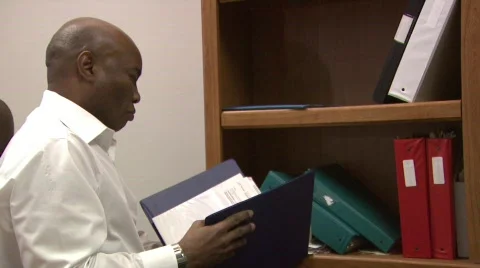 Man goes through files Stock Footage 479739
