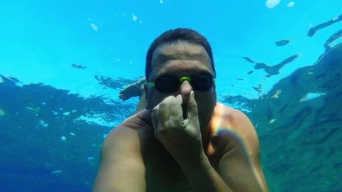 Man with a goggles dive deep in the water Stock Footage 281241117