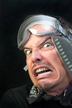Man in goggles with knife, afraid Stock Photos