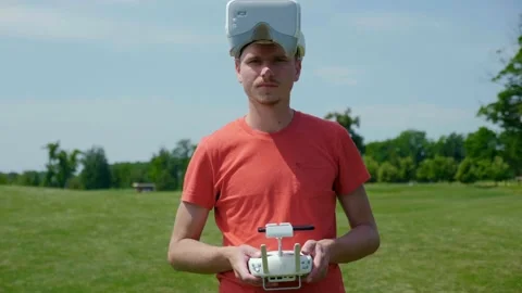 Man in goggles for a quadrocopter and with remote control in his hands Stock Footage 134234475