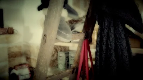 A man going up and down an old ladder at home (a tiny cozy one). Angled Stock Footage 249520987