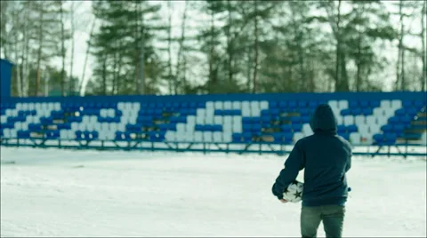 Man going with ball to stadium tribune and taking the place there Stock Footage 63534607