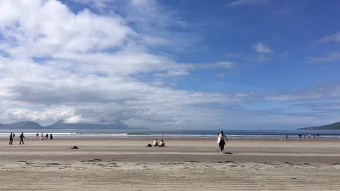 Man Going To The Beach Holding Surfboard on Sunny Summer Day, Dingle, Ireland Stock Footage 90819385