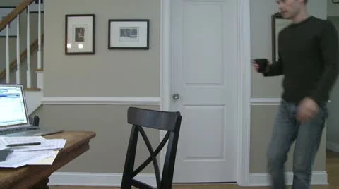A man going to dining room table to work on his finances (1 of 4) Stock Footage