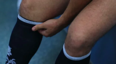 Man is going to do sports work out - putting on socks Stock Footage 68926921
