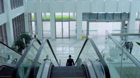 Man going down escalator Stock Footage 235275379