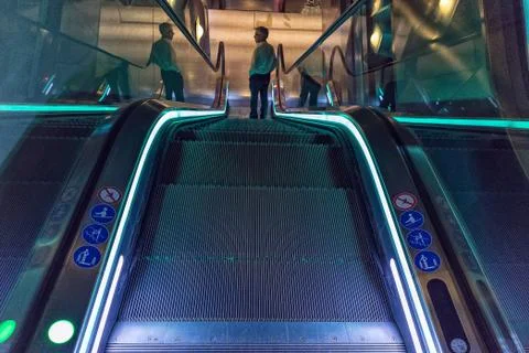 Man going down escalators Stock Photos