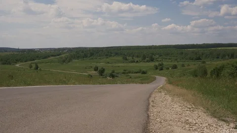 Man going down a hill on longbone in the forest Sunny summer day. Frame from a Stock Footage 111286182