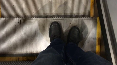 Man going down on a moving escalator Stock Footage