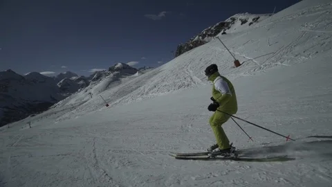 Man going down a ski slope in the Alps, Serre-Chevalier, France Stock Footage 103318384