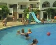 Man going down small slide into pool SD Footage