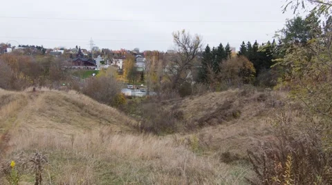 Man going downhill &amp; uphill with a log on the shoulders (BMCC 2.5K - 2400x1350) Video stock 47943621