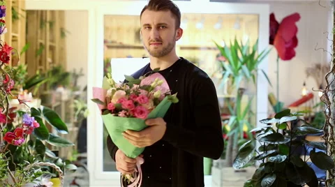 The man is going to give a beautiful flowers to girl. Stock Footage 62926294