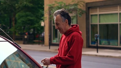 Man Going Into His Automobile Stock Footage 78544457