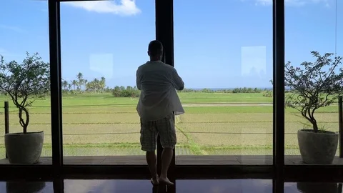 Man going outside and feels joyful while jumping on the terrace, steadycam shot Stock-Footage 82994794