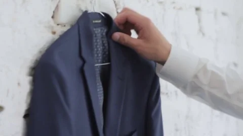 Man is going to put on a jacket close-up Stock Footage 73290452