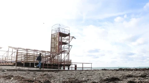 Man going to the sea in Old station Stock Footage 99698409