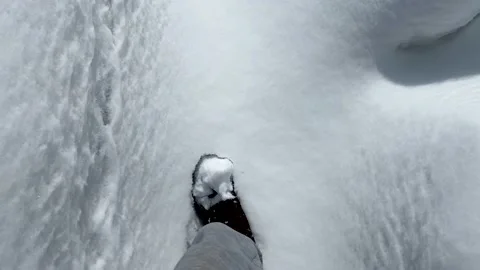 Man going on snow in winter, leaving footprints on fresh snow. View from eyes. Video stock 172575430