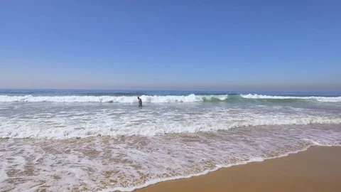 Man Going Swimming in Ocean Waves Stock Footage 84109144