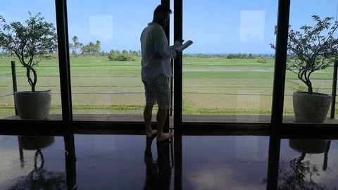 Man going on the terrace and reading book, steadycam shot Stock Footage 82994740