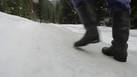 Man going through pine forest on a road covered with snow Stock Footage 71757111