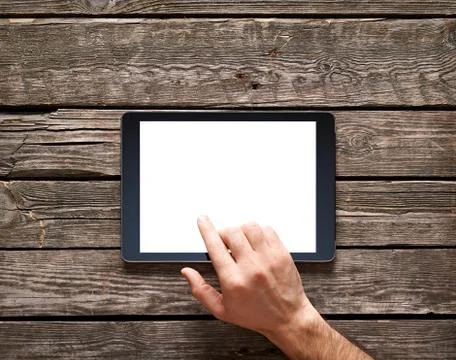 Man is going to touch screen of digital tablet Stock Photos