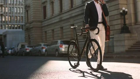 Man going to work with cycle using phone Stock Photos