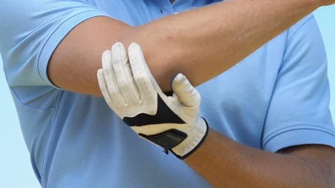 Man in golf uniform developing elbow feeling pain and cramp, joint problems 스톡 동영상 114338835
