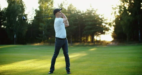 A man golfer in a cap plays on the field. Time for golf Stock Footage 220444655