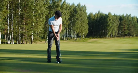 A man golfer in a cap plays on the field. Time for golf Stock Footage 220573533